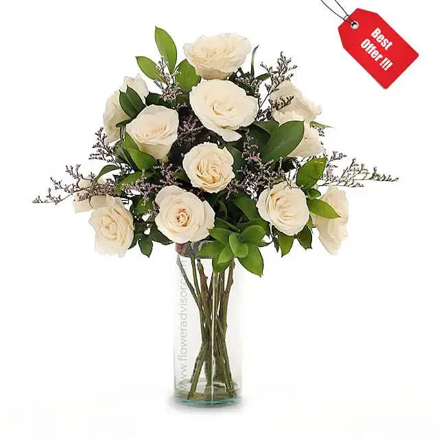 12 white roses with greenery in a glass vase for online flower delivery