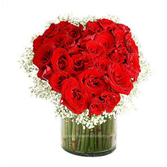 Fresh red rose bouquet with white fillers in glass vase, ideal for flower delivery