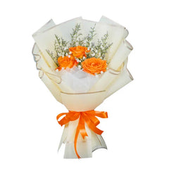 Orange rose bouquet with white filler flowers, wrapped for flower delivery in Singapore