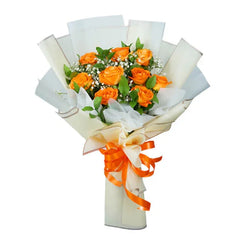 Orange rose bouquet with greenery and baby's breath, wrapped for flower delivery