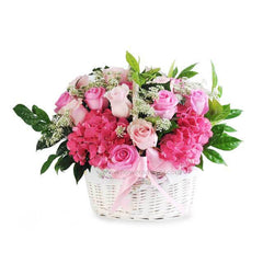 Basket of pink roses, hydrangeas, and baby's breath for flower delivery