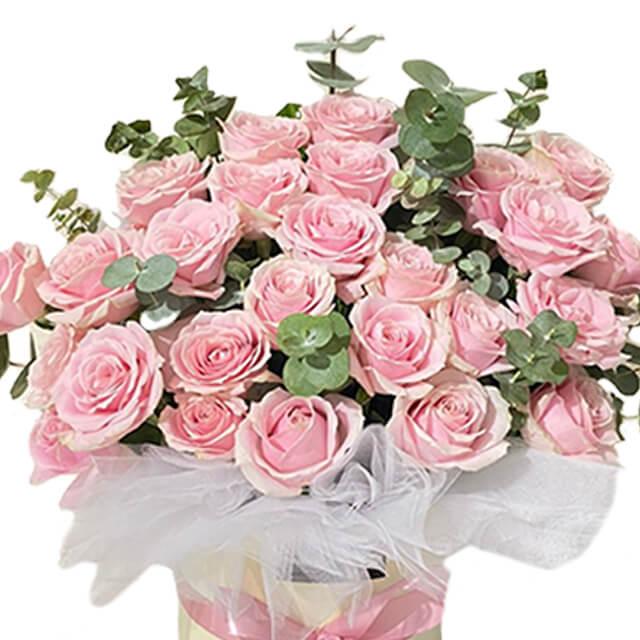 Pink roses bloom box arrangement with greenery, perfect for flower delivery in Singapore