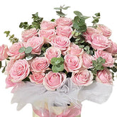 Pink roses bloom box arrangement with greenery, perfect for flower delivery in Singapore
