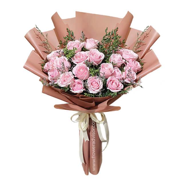 Hand bouquet of 20 pink roses in brown wrapping for flower delivery