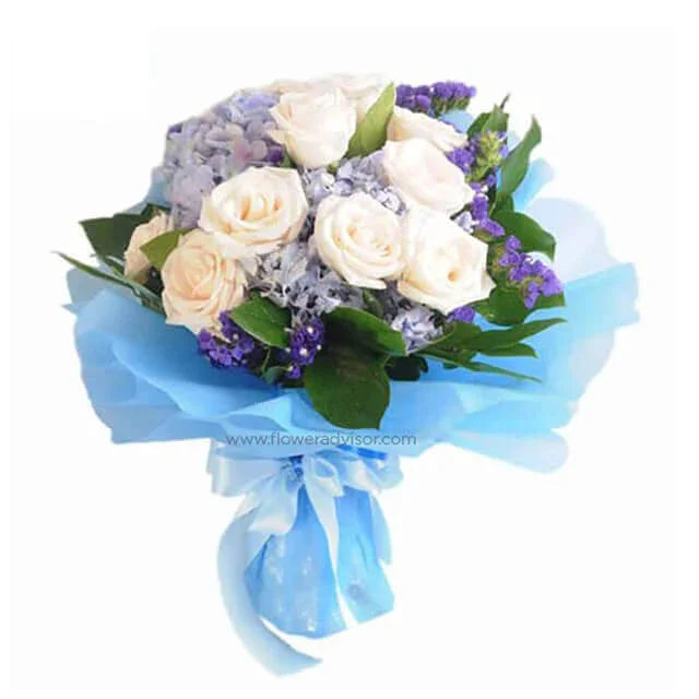 Bouquet of white roses and blue hydrangeas with purple accents for flower delivery