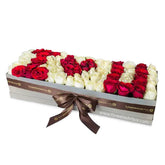 Luxury box of mixed red and white roses spelling I Love You, perfect for flower delivery