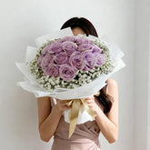 Bouquet of purple roses with baby's breath, ideal for Singapore flower delivery.