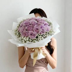 Bouquet of purple roses with baby's breath, ideal for Singapore flower delivery.