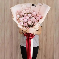 Hand bouquet of 24 pink roses with baby's breath, perfect for flower delivery in Singapore
