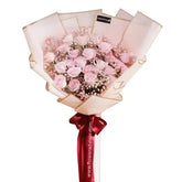 Hand bouquet of 24 pink roses with pink fillers, perfect for flower delivery in Singapore