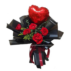Hand bouquet of five red roses with greenery and heart-shaped balloon for flower delivery