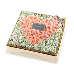 Heart-shaped pink rose flower arrangement in a gift box for flower delivery