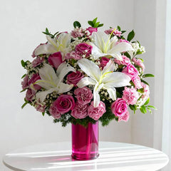 Elegant flower delivery bouquet with white lilies, pink roses, and carnations in a pink vase