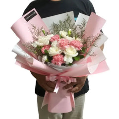 Handheld pink and white flower bouquet with ribbon, ideal for Singapore flower delivery
