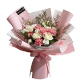 Pink and white hand bouquet with carnations and roses for flower delivery
