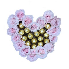 Heart-shaped box with pink roses and gold chocolates, perfect for flower delivery