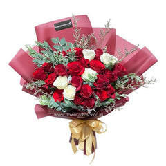 Elegant hand bouquet with red and white roses, perfect for fast flower delivery in Singapore