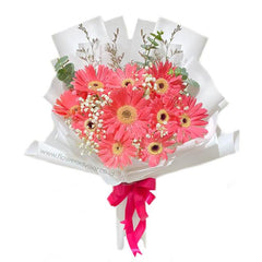 Pink gerbera daisy bouquet with white baby’s breath, perfect for flower delivery in Singapore