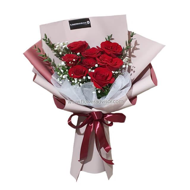Hand bouquet of 8 fresh red roses with greenery and baby’s breath for flower delivery