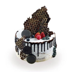 Artisanal cream cake with chocolate decor and berries, elegant cake for flower delivery gifts