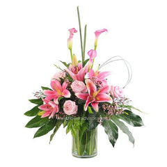Assorted pink lilies and roses in glass vase, ideal for flower delivery in Singapore.