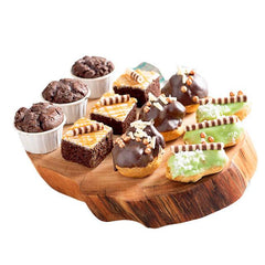 Assorted gourmet cupcakes and pastries on wooden tray, ideal gift with flower delivery Singapore