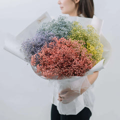 Colorful baby’s breath bouquet for flower delivery, wrapped in white paper