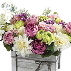 Colorful mixed artificial flower arrangement in a wooden box for flower delivery