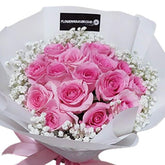 Elegant hand bouquet of pink roses and baby's breath, perfect for flower delivery