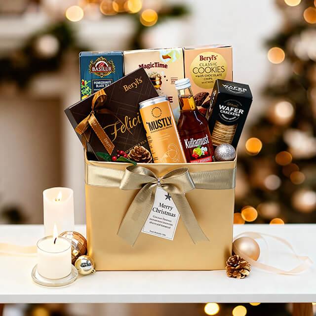 Festive gift hamper with chocolates, tea, cookies, and candles, ideal for flower delivery gifts