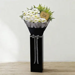 Elegant condolence flower stand with white chrysanthemums and sympathy card for delivery