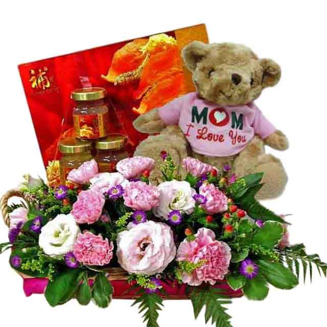 Flower delivery basket with pink and white flowers, teddy bear, and hamper gift set