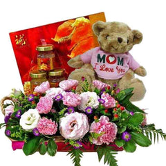 Flower delivery basket with pink and white flowers, teddy bear, and hamper gift set