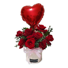 Flower delivery with box of eight red roses and red heart-shaped balloon, gift arrangement