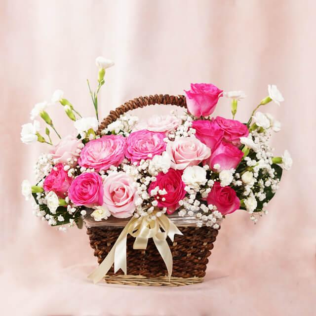 Pink and white flower basket arrangement with roses and baby's breath for flower delivery