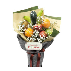 Fresh fruit bouquet with apples, oranges, baby's breath and gift wrap for flower delivery