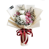 Elegant flower delivery bouquet with white roses, pink orchids and baby's breath, wrapped with red ribbon