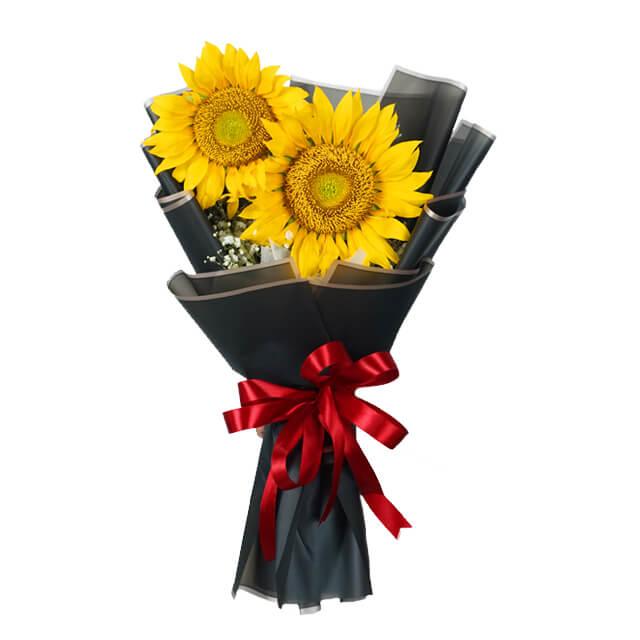 Sunflower bouquet with red ribbon for flower delivery, elegant black wrapping