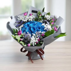 Elegant flower bouquet with blue roses, pink and white flowers, perfect for flower delivery