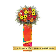 Standing flower arrangement with red, yellow, and orange blooms for flower delivery