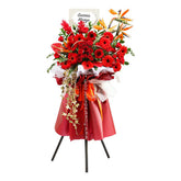 Grand opening flower stand with bright red gerberas, roses, and exotic blooms for delivery