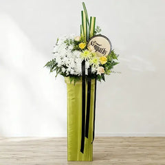 Sympathy flower stand with white and yellow blossoms for funeral flower delivery