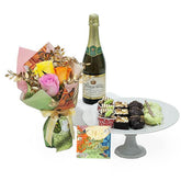 Festive flower bouquet with assorted treats and sparkling juice for Hari Raya flower delivery