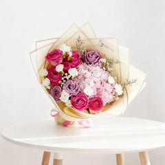 Elegant bouquet with pink roses, purple flowers and white blooms for flower delivery Singapore