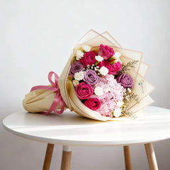 Elegant fresh flower bouquet with pink and purple roses for express flower delivery