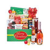 Festive Christmas hamper with assorted snacks, chocolates, wine, and a Merry Christmas gift box, perfect for flower delivery gifts.