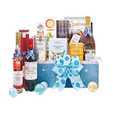 Luxury gift hamper with wine, gourmet snacks, chocolates and festive blue ribbon, ideal for flower delivery gifts