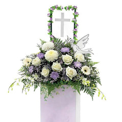 Fresh condolence flowers stand with white and purple blooms for flower delivery
