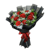 Red rose bouquet with baby's breath in black wrapping for same-day flower delivery