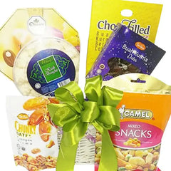 Gift hamper with snacks, dates, and a green ribbon, ideal for flower delivery gifting